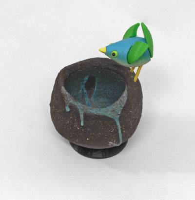 stoneware bird nest I, with green bird by Chris Barnes
